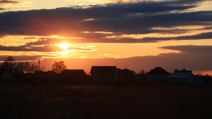 Sunset over city. Evening city landscape. Sunset over multi-story buildings. City line with colorful sky. Cityscape with summer sunset.