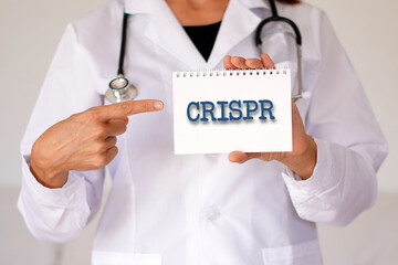 crispr concept. woman doctor with the acronym of this molecular tool written in her notebook