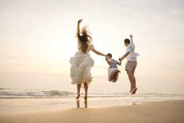 Asian family beach vacation. Children parent relax together. People lifestyle.