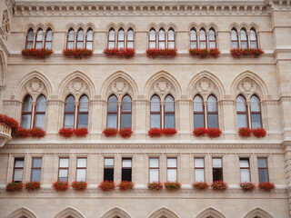 Majestic Vienna Town Hall in the city center - details of historic neo-Gothic landmark. Vienna's iconic Town Hall, a grand symbol of history and culture, glowing under the summer sky.