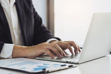 Fototapeta premium Businessman using computer to record company activity list.