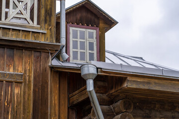 Rustic Architecture: A glimpse of Old Wooden House with Window & Metal Drainage System