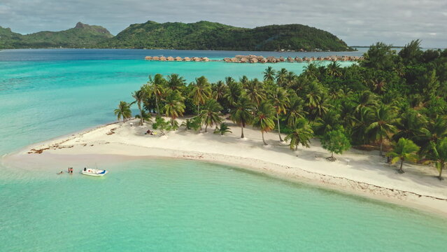 Multiple aerial views show a tropical island resort in Bora Bora with overwater bungalows, palm trees, white sand beaches, and stunning turquoise waters