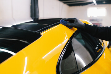 Process of applying a ceramic coating to the sports car surface for protection during detailing...