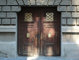 Old brown door on the old stone wall - Image - Image
