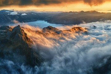 Fototapeta premium Mountain Peaks Emerging From Clouds at Sunrise Aerial View Landscape
