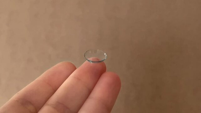 Contact lens close-up on a child's finger. Modern methods of treatment and correction of vision in children. Advertisement for clinics and medical products. Optometry . High quality 4k footage