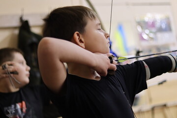 young boy is shooting 