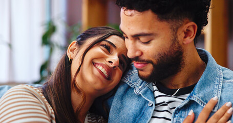 Obraz premium Home, hug and couple on sofa, love and bonding together with marriage, happiness and care. Embrace, apartment and man with woman, calm and resting with romance, relationship and relax in living room
