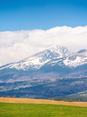 tatra mountain landscape in spring. scenic nature of europe for travel. slovakia countryside scenery with snow on the peak. beautiful alpine view with blue sky and cloud for tourism