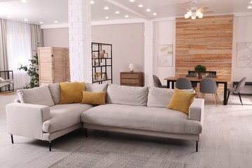 Fototapeta premium Stylish living room interior with comfortable sofa and wooden table
