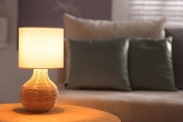 Stylish night lamp on wooden table in room, space for text