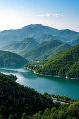 Obraz premium mountains surrounding a lake with a road going through it
