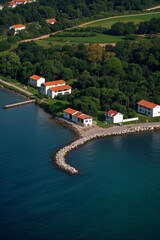 Fototapeta premium aerial view of a small island with a lighthouse and a house