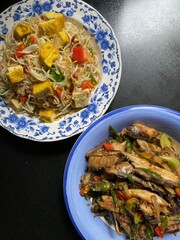 Prepared dishes of food including fish and a vegetable medley