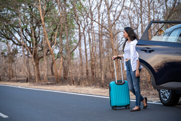 Young girl traveler waiting outside the car with backpack.