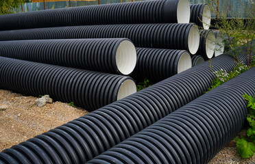 Stack of PVC U canalization pipes plumbing tube on a hardware store stock.