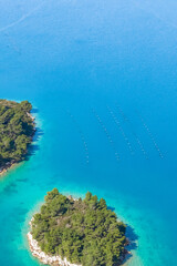 Nature sea backdrop with a bay between continental Croatia and the Pelješac Peninsula in the Dalmatia Region. Oyster farms