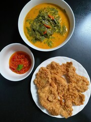 A Deliciously Prepared Meal With Fried Food And Vegetables