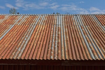 Rusty corrugated metal roof wall texture background.