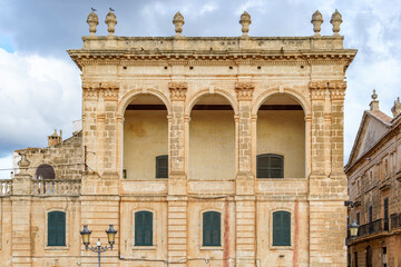 Obraz premium Capture the grandeur of Palace Torresaura in Ciutadella, Menorca. This architectural gem features a historic facade, arched windows, and Balearic elegance. Travel, culture, architecture themes