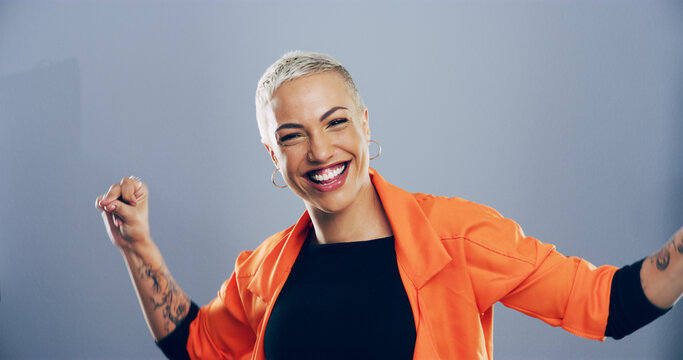 Dance, energy and portrait of excited woman in studio for celebration, clubbing or party fun. Moving, music and smile of happy dancer person on gray background for beat, choreography or rhythm