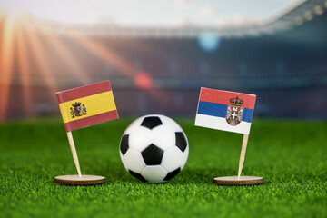 spain and serbia football match with national flags, soccer ball on green field, and stadium background, representing international sports competition and rivalry