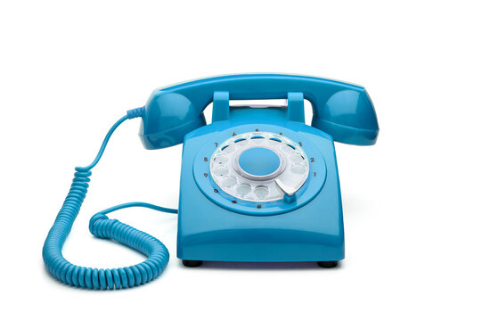 Old, blue rotary telephone isolated on white background