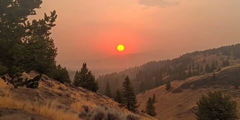 Sunset over hazy hills, orange sky