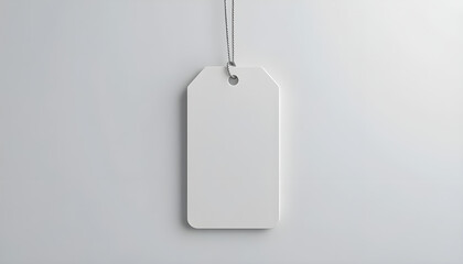 Blank White Price Tag Hanging Against a Plain Background