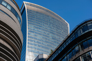 Futuristic skyscrapers in London with reflective surfaces, emphasizing modern city aesthetics and design.