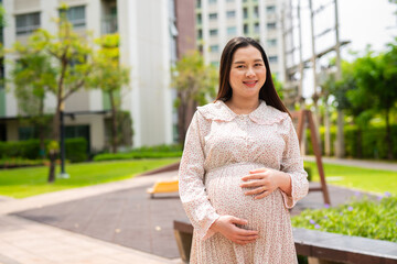 Pregnant woman portrait in park