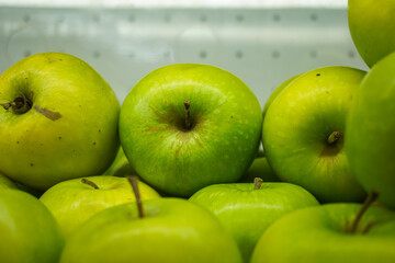 View of fresh green Apples on a fruit shop shelf. Healthy apples.