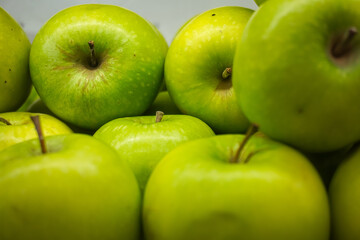 View of fresh green Apples on a fruit shop shelf. Healthy apples.