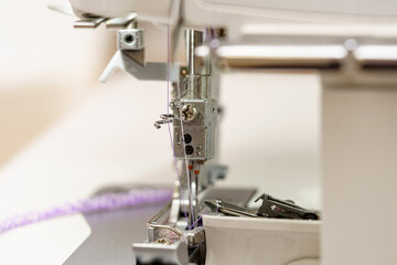 Sewing machine in operation close-up, threads and needles.