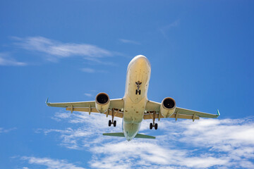 
 Mai Khao beach Phuket Thailand. Airplane Landing over sea at Phuket Airport, popular landmark tourists people come to take photo of the plane landing near the beach