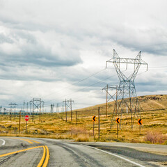 Empty road and high-voltage power pole