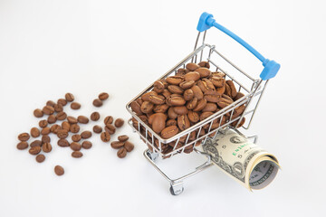 Miniature shopping carts filled with coffee beans and dollar bills on a white background, representing the coffee trade and financial transactions.