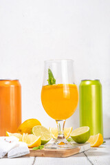 Trendy Tea Inspired cocktail set from green, oolong, black, chai and other tea blends. Sparkling tea soda, cold summer drinks with syrup, lemon, lime and mint, on sun lighted white wooden background