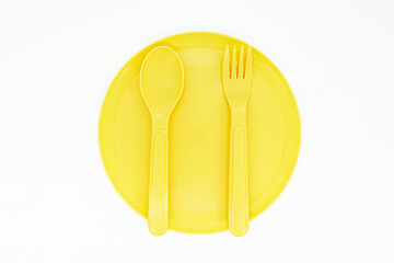 Yellow Plastic Cutlery and Plate on White Background