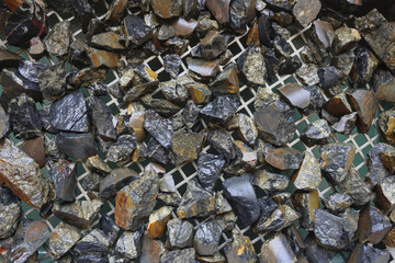 Mine, mining of tin (Sn) ore, as mineral cassiterite (SnO2). Background concept. Element used in...