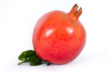 Ripe pomegranate fruit with leaves isolated on white background.