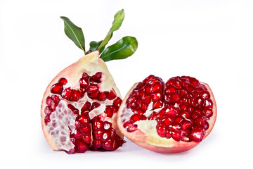 Ripe pomegranate fruits with leaves isolated on white background.