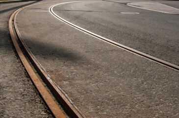 Tram rails on a deserted asphalt road