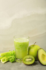 Green smoothie in glass made from kiwi, celery, apples. Detox concept, healthy food, diet,...