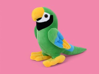 Colorful green parrot toy on the pink background © Maya