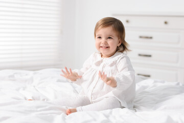 Fototapeta premium Cute little baby girl on bed at home. Space for text