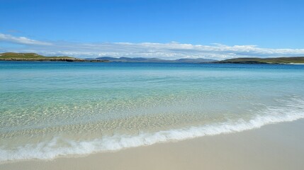 Fototapeta premium Crystal-clear turquoise waves gently lapping against a pristine white sandy shore under a bright blue sky