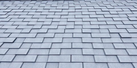 Sleek grey and black asphalt shingles on a modern roof, aerial, abstract