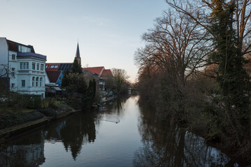 Obraz premium Outdoor scenery over the bridge and ems river in Telgte, Germany during sunset. 